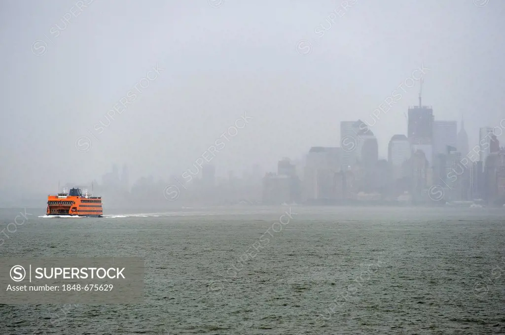 Staten Island Ferry and thunderstorms over Manhattan, New York, USA