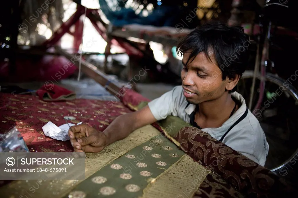 Cottage industry, man embroidering a piece of cloth with sequins, Calcutta, Kolkata, West Bengal, India, Asia