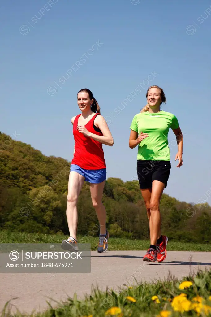 Two recreational runners, young women, 25-30 years, jogging