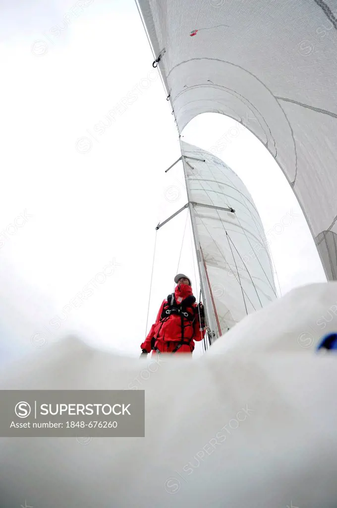 Man wearing rain gear and a life jacket, sailing on the North Sea