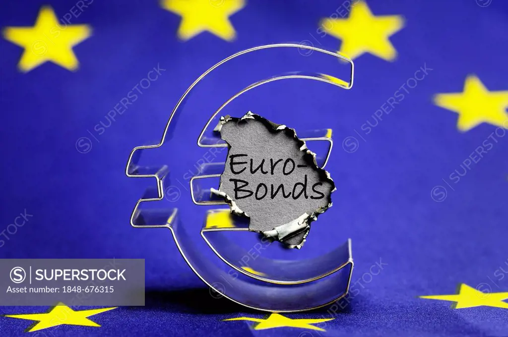 Euro symbol on the EU flag with a burn mark and the word Euro-Bonds, symbolic image of the euro crisis
