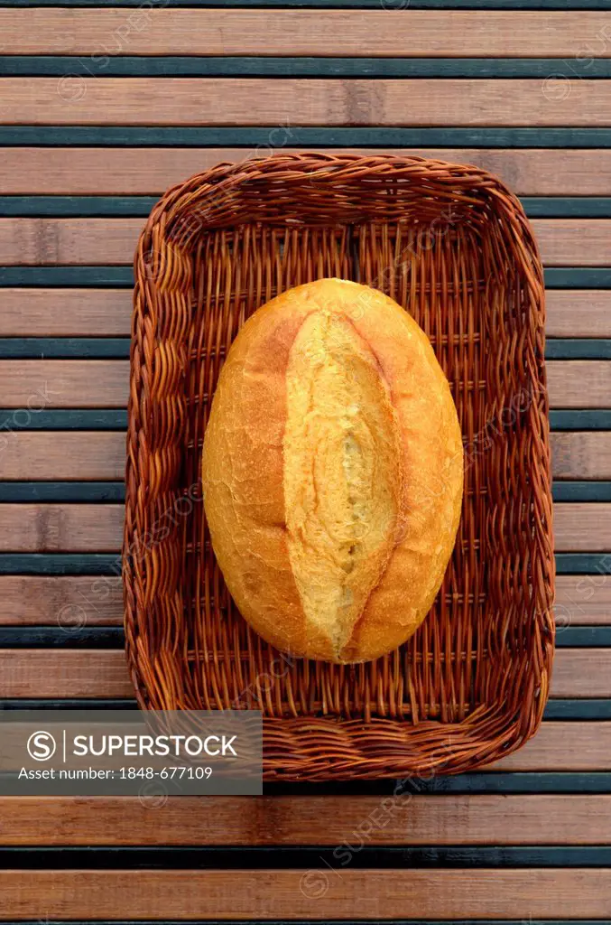 A single bread roll in a basket