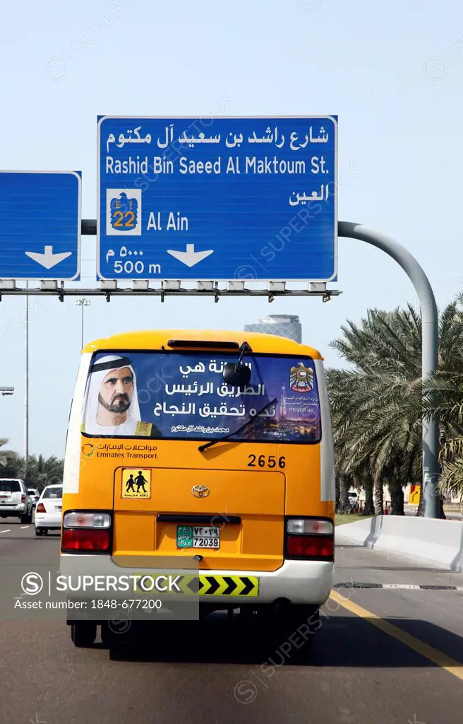School bus displaying the picture of Muhammad bin Rashid Al Maktoum, the ruler of the Emirate of Dubai, bus driving on a motorway in Abu Dhabi, United...