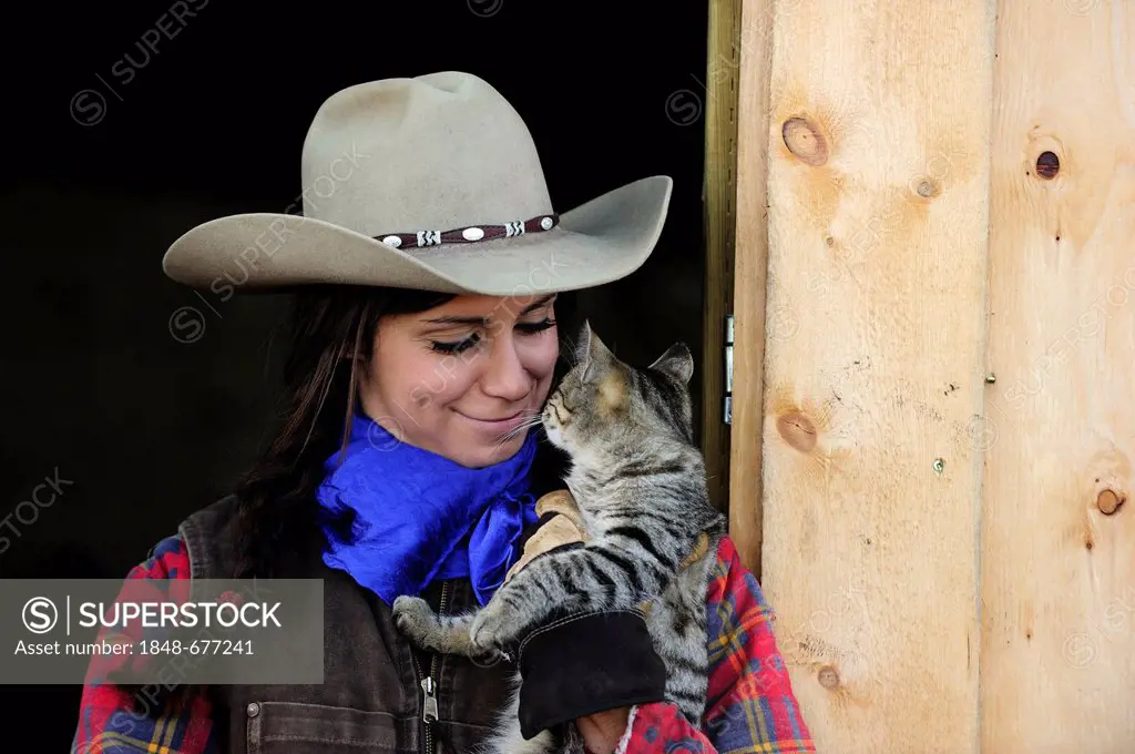 Cowgirl with cat, portrait, Saskatchewan, Canada, North America