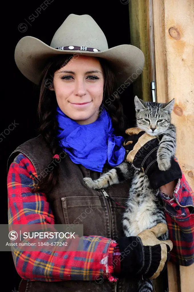 Cowgirl with cat, portrait, Saskatchewan, Canada, North America