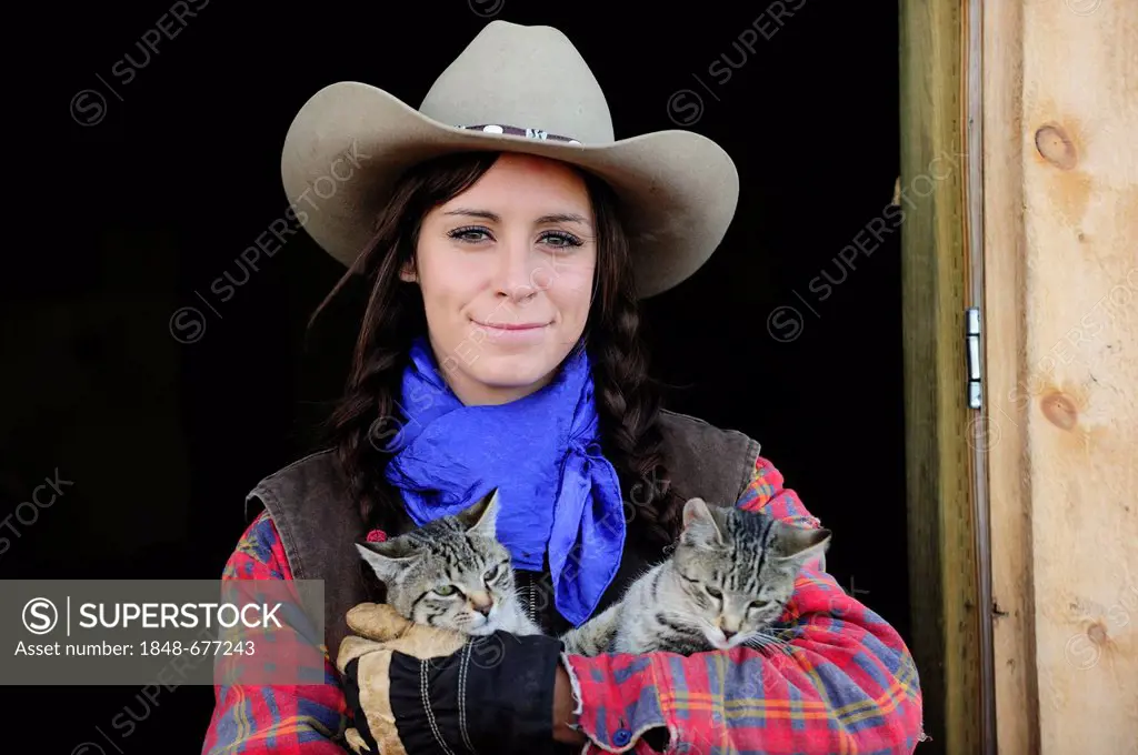 Cowgirl with two cats, portrait, Saskatchewan, Canada, North America