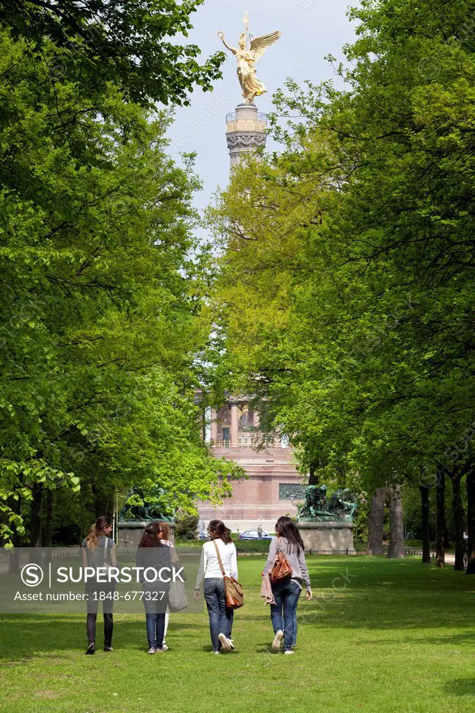 Young female tourists strolling through Berlin's Tiergarten park towards the Siegessaeule, Victory Column, Berlin, Germany, Europe
