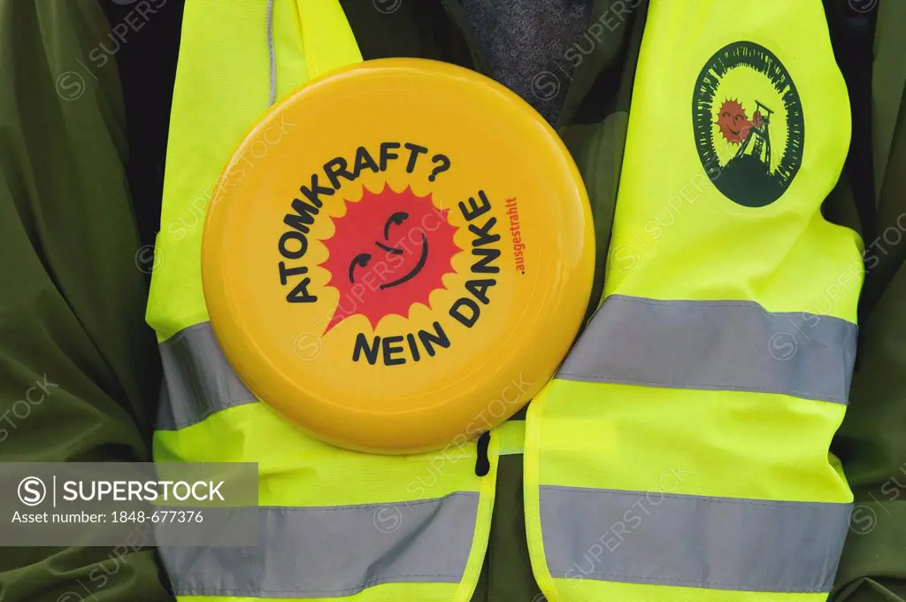 Anti-nuclear protester wearing a waistcoast, Atomkraft Nein danke, German for nuclear power, no thanks smiling sun, logo of the anti-nuclear movement
