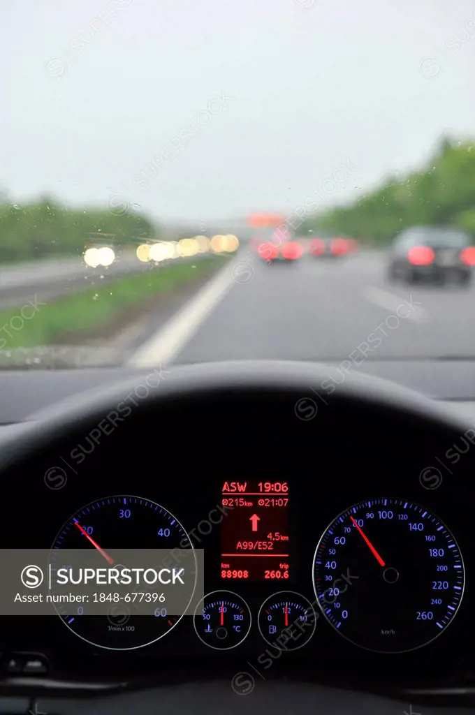 Poor visibility in rain, highway, illuminated speedometer with navigation display, driving VW Golf