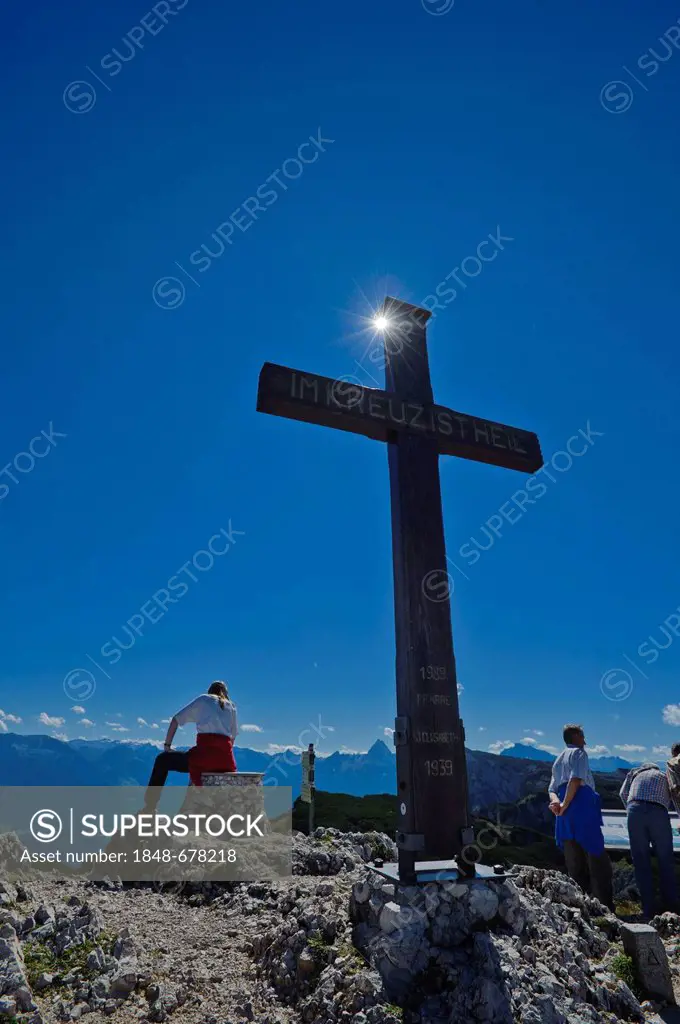 Cross on the summit of Salzburg Hochthron mountain, hiker taking a break, Untersberg, Groedig, Salzburg, Austria, Europe