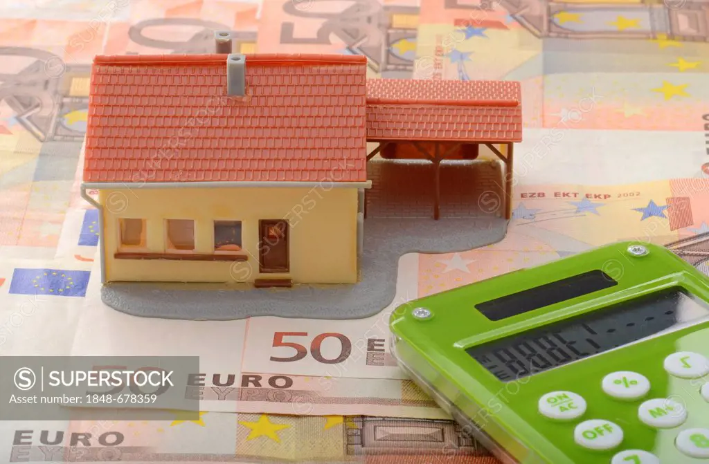 Miniature house with carport on 50 euro notes and a calculator, symbolic image for property market