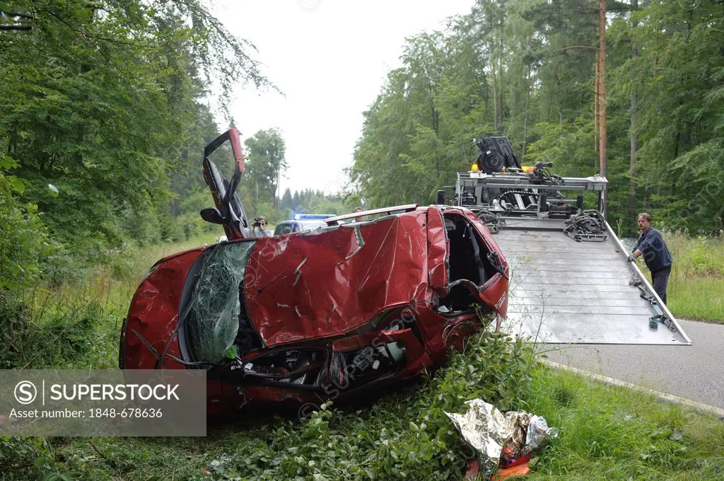 A damaged red Suzuki Swift is lying on its roof after a road traffic accident on the K 1209 road, Lichtenwald, Baden-Wuerttemberg, Germany, Europe