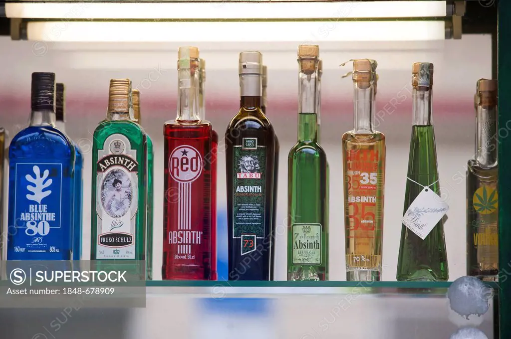 Absinthe bottles on a glass shelf, Prague, Bohemia, Czech Republic, Europe