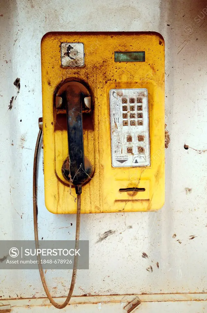 Old, yellow, weathered phone, phone booth in Laos, Southeast Asia, Asia