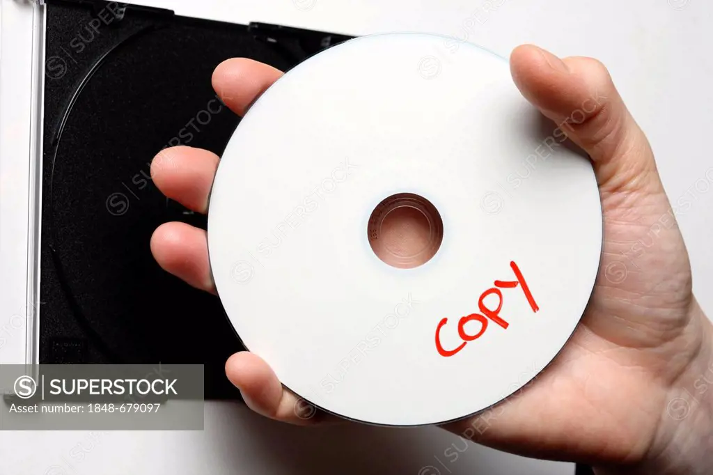 Hand holding a CD or DVD labeled copy