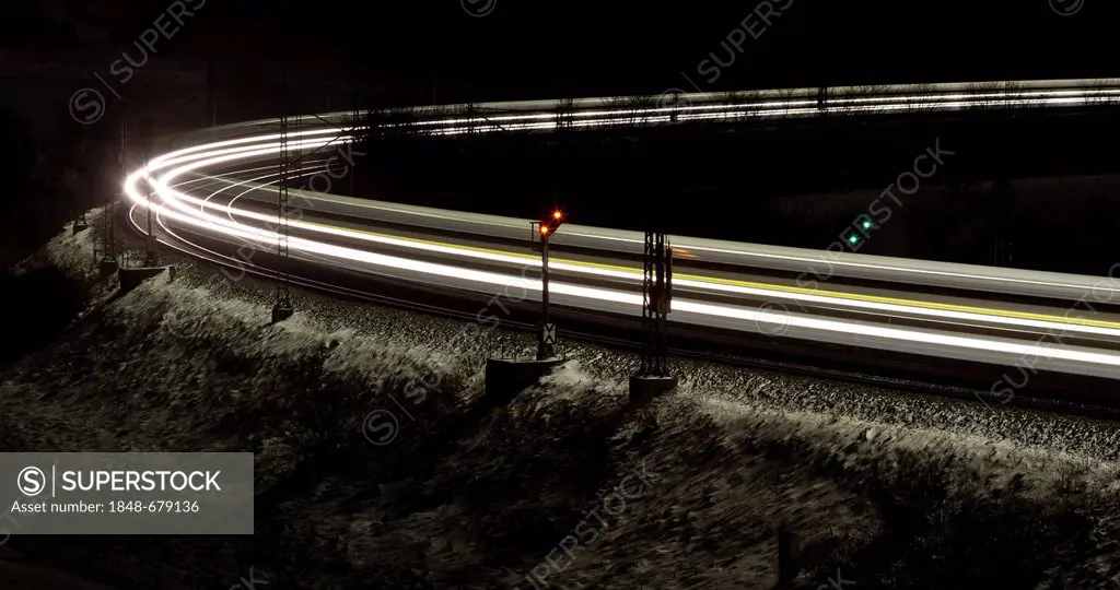 Train as a light trace in winter at night, Lonsee, Baden-Wuerttemberg, Germany, Europe