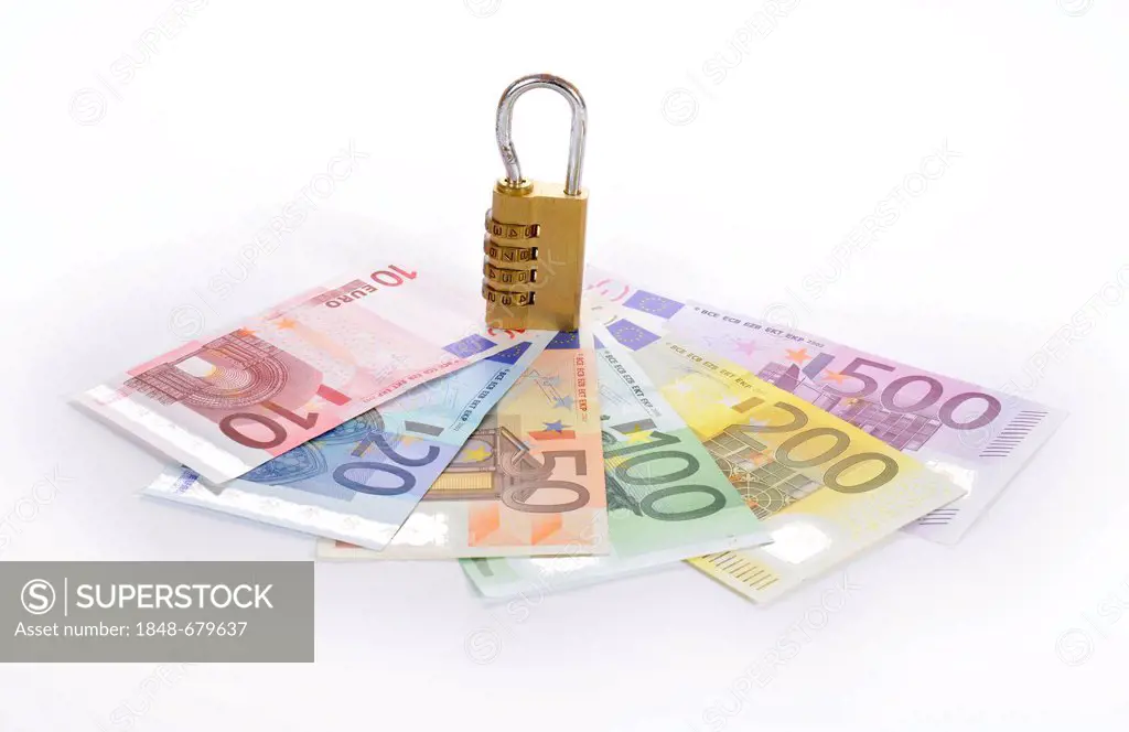 Combination lock on euro banknotes, symbolic image of monetary security