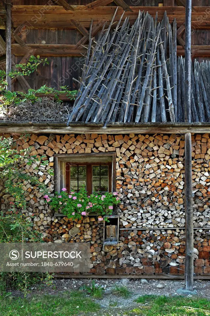 A wood pile and hay drying racks, Bauernhausmuseum Amerang farmhouse museum, Amerang, Bavaria, Germany, Europe