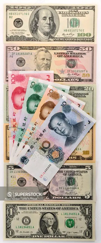 Symbolic image for exchange rates, U.S. dollar banknotes and a fan of Chinese yuan, renminbi, currency of the People's Republic of China, in the West ...