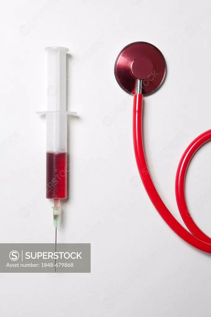 Syringe with blood and a stethoscope, blood donation, taking of a blood sample
