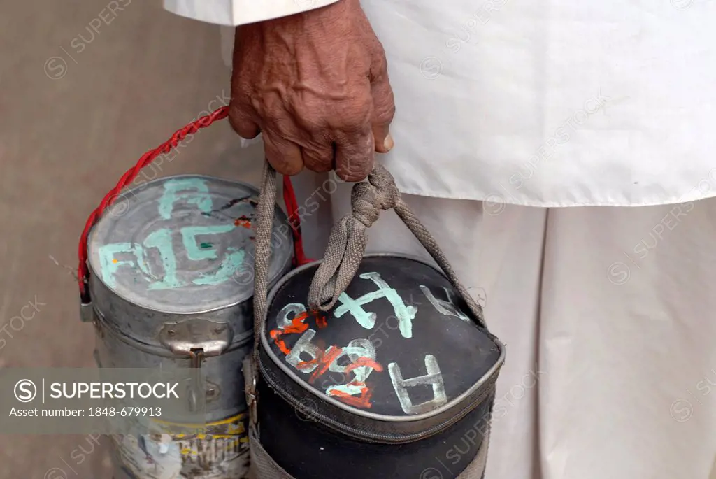 Dabba wallah or food deliverer with Dabbas or food containers marked with characters to allow correct delivery, Mumbai, India, Asia