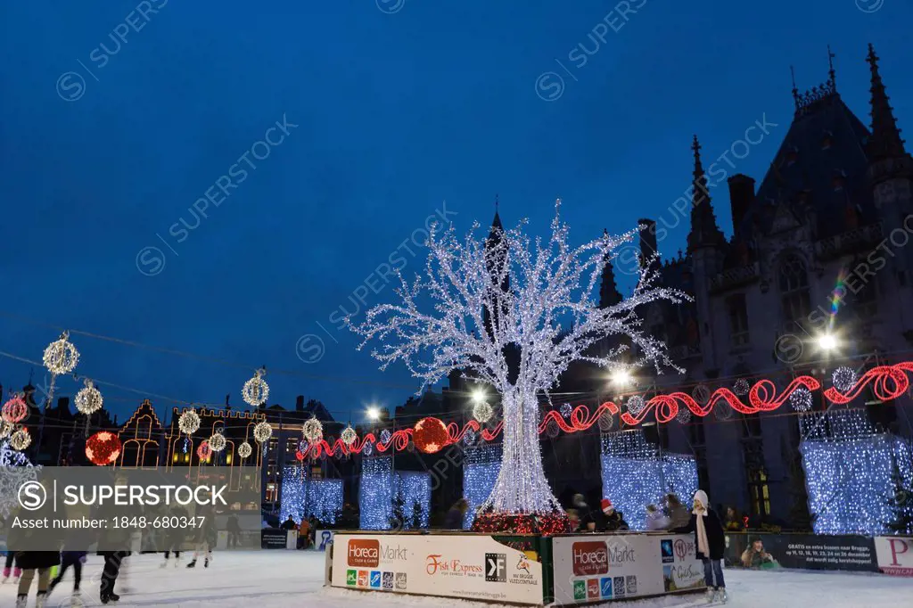 The ice rink on the Grote Markt market square in winter, Bruges, Brugge, West Flanders, Flemish Region, Belgium, Europe