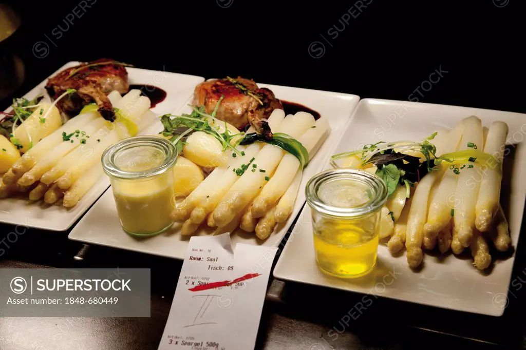 Fresh asparagus with lamb chops, Hollandaise sauce and melted butter, plates with order slip for read for the waiter