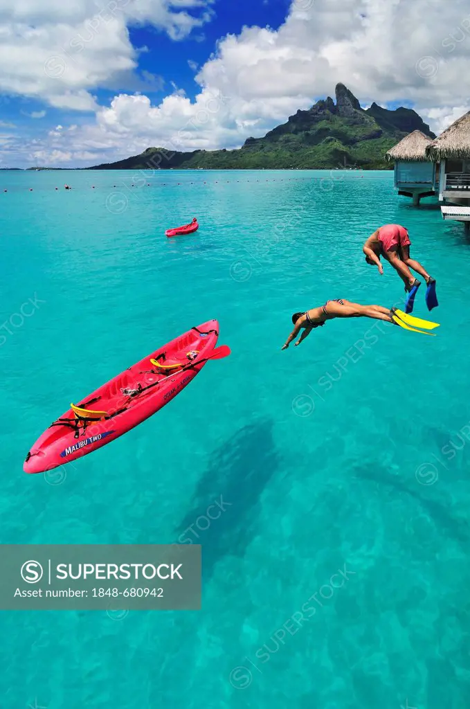 Tourists jumping into the water, St. Regis Bora Bora Resort, Bora Bora, Leeward Islands, Society Islands, French Polynesia, Pacific Ocean