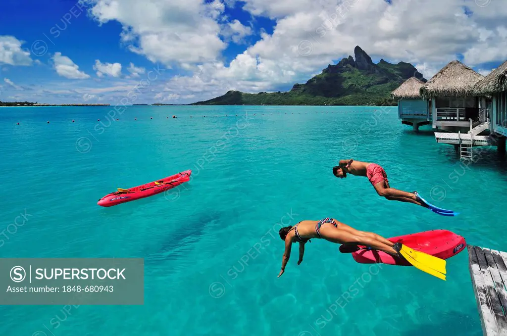 Tourists jumping into the water, St. Regis Bora Bora Resort, Bora Bora, Leeward Islands, Society Islands, French Polynesia, Pacific Ocean