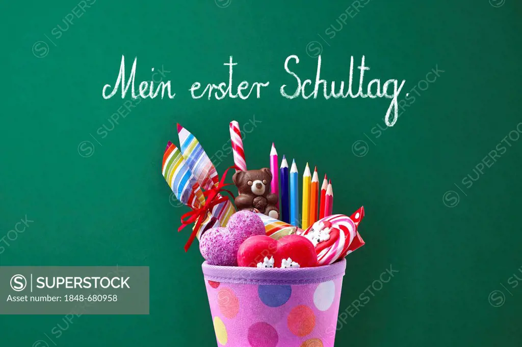 Schultuete or school cone with gifts and sweets in front of a school blackboard with the message Mein erster Schultag, German for My first day at scho...