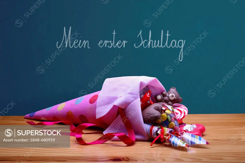 Schultuete or school cone with gifts and sweets in front of a school blackboard with the message Mein erster Schultag, German for My first day at scho...