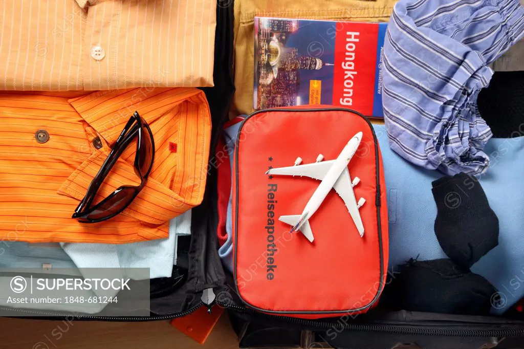 Holiday luggage, first-aid kit, travel guides, sunglasses