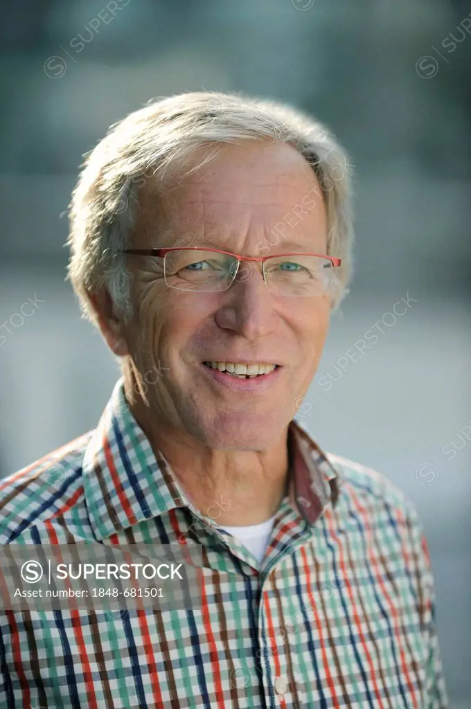 Friendly elderly man, early 60's, wearing glasses, portrait