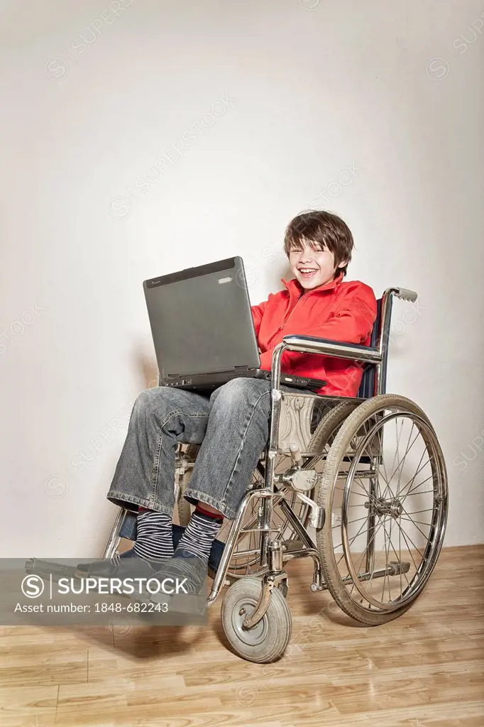 Boy in a wheelchair using a laptop