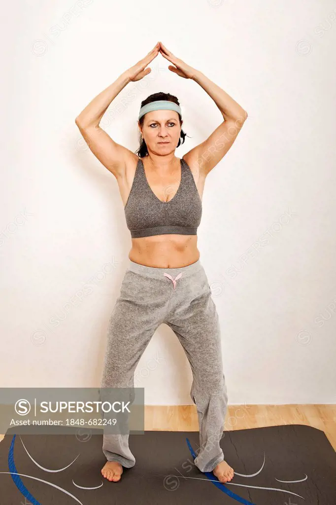 Woman on an exercise mat, doing yoga or gymnastics