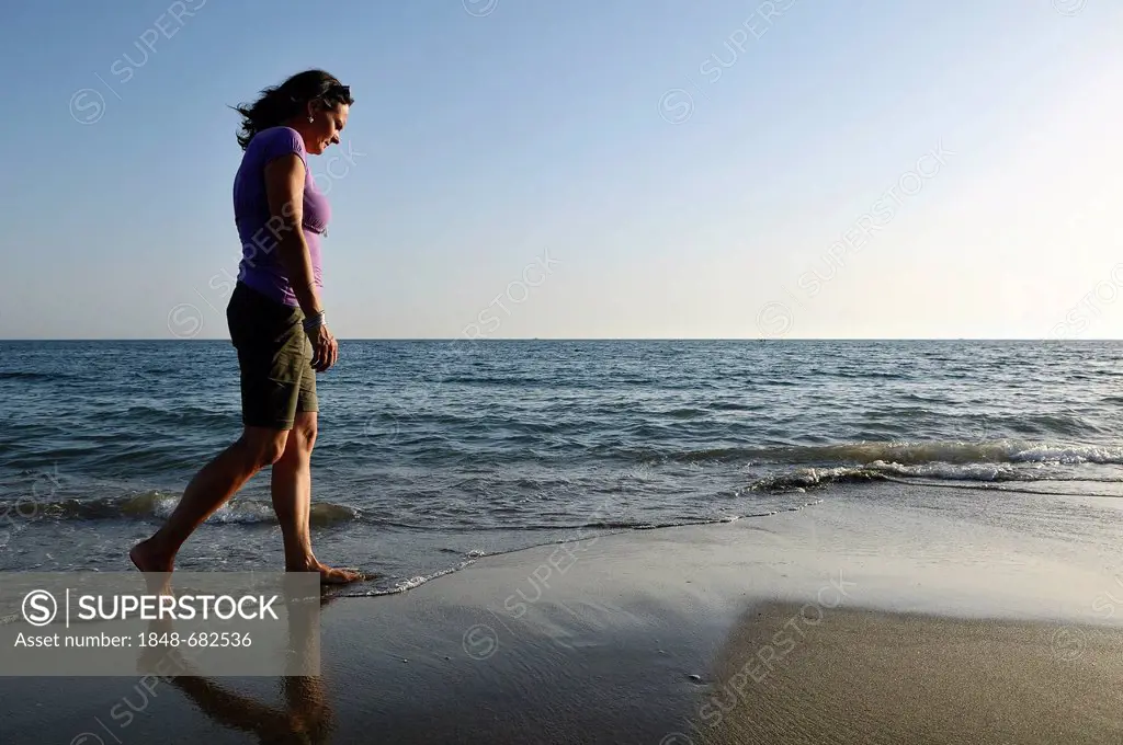 Woman walking on the beach, Lido di Ostia, Rome, Lazio region, Italy, Europe