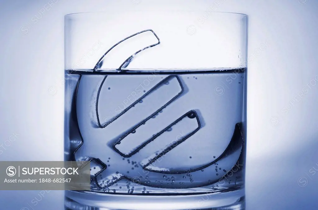 Euro sign in a glass of water, symbolic image for euro crisis