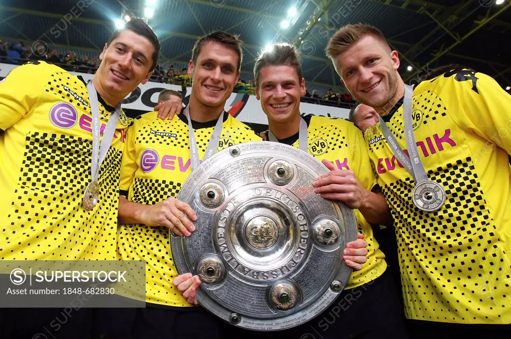 BVB Borussia Dortmund players with the league cup trophy, from left, Robert Lewandowski, Sebastian Kehl, Lukasz Piszchek, Jakub Kuba Blaszczykowski, a...