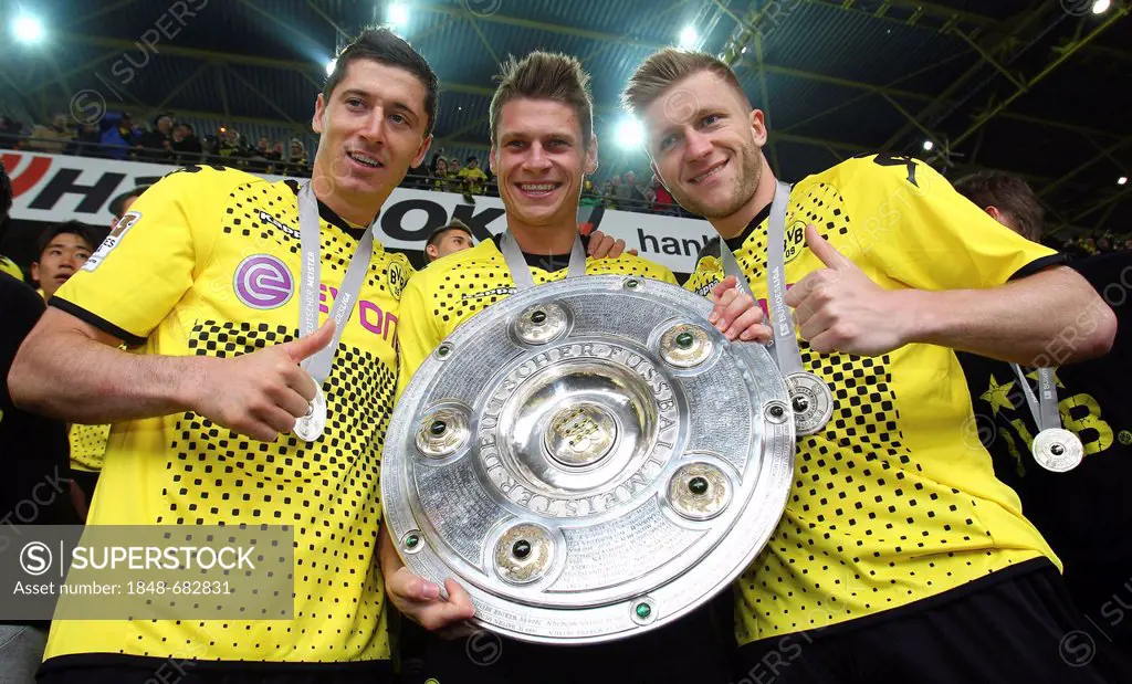 The Polish BVB Borussia Dortmund players, from left, Robert Lewandowski, Lukasz Piszczek and Jakub Kuba Baszczykowsi holding the league cup trophy, af...