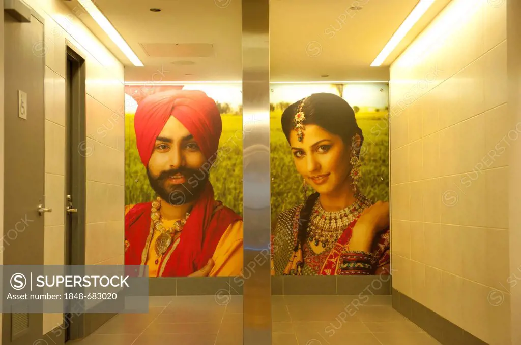 Modern and inviting entrance to restrooms, men's toilet on the left, picture of an Indian man wearing a turban, women's toilet on the right, picture o...