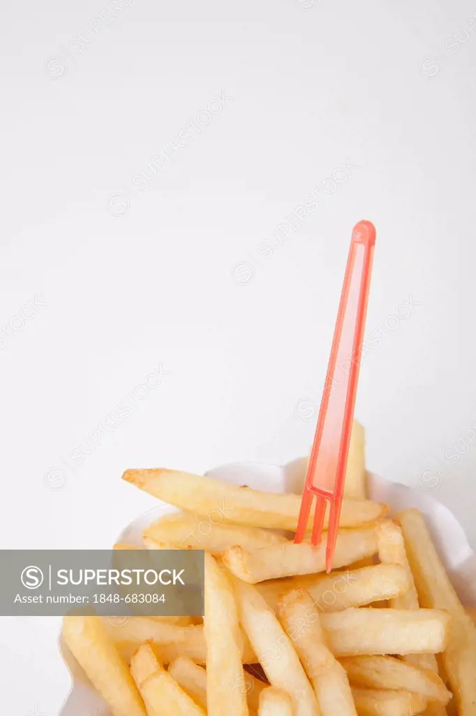 French fries on a paper plate with a snack fork