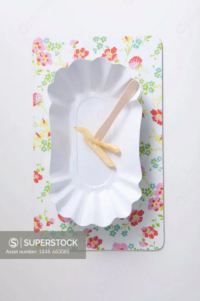 French fries on a snack fork on a paper plate, diet