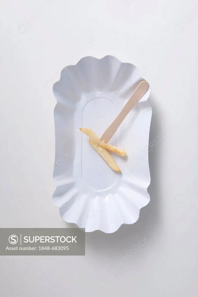 French fries on a snack fork on a paper plate, diet