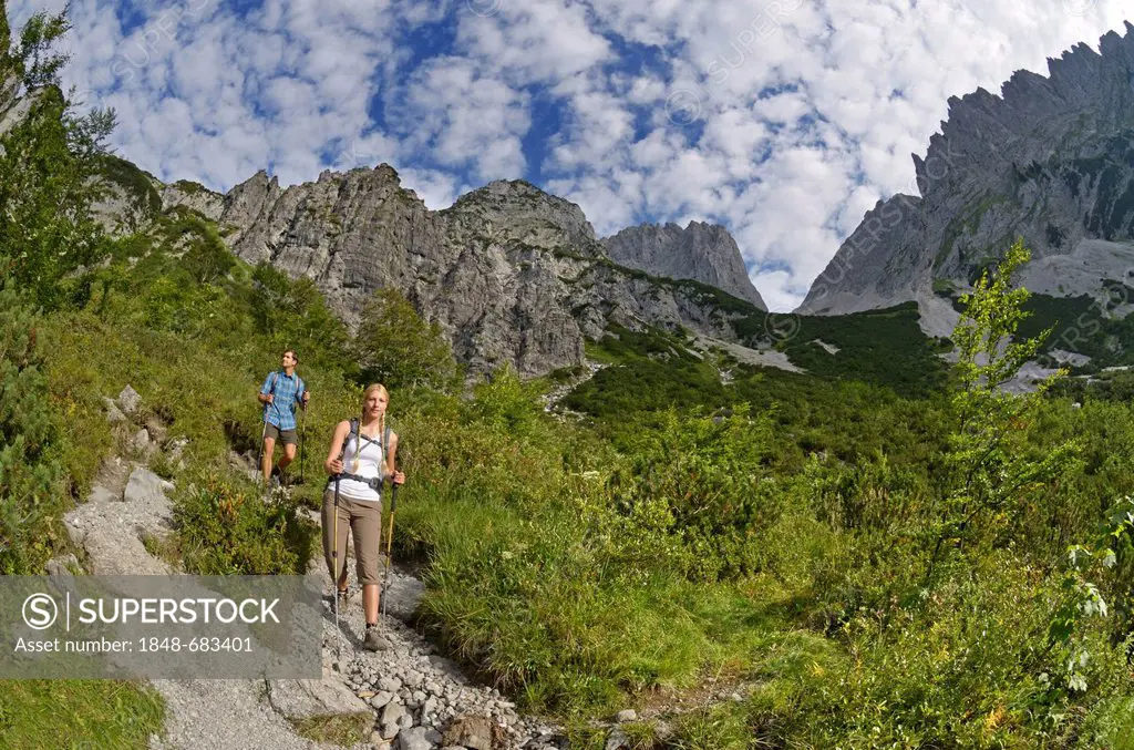 Hikers descending from Gruttenhuette mountain lodge, Karlspitze mountain, Ellmauer Tor mountain ridge, Wilder Kaiser mountain, Tyrol, Austria, Europe