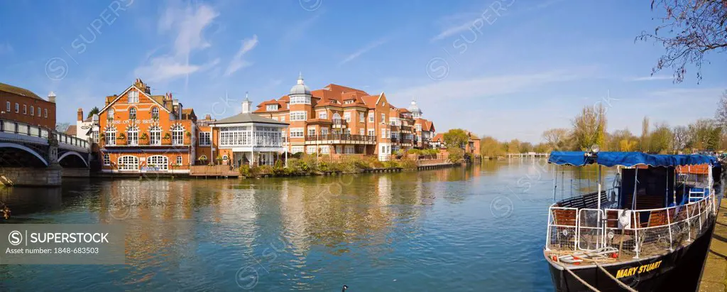 Windsor Bridge, House on the Bridge Restaurant and King Stable Street properties by the river Thames in Eton viewed from Windsor, Berkshire, England, ...