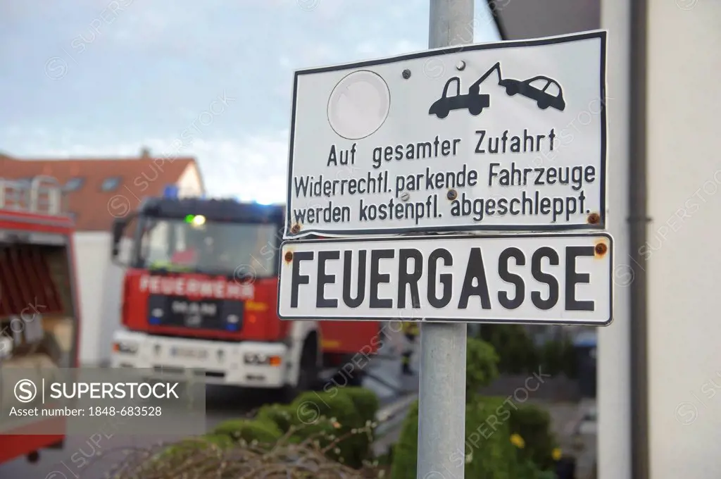 Sign, Feuergasse freihalten, German for keep clear lane for fire engines, fire engines at back during a fire fighting operation at a barn fire, Aichel...