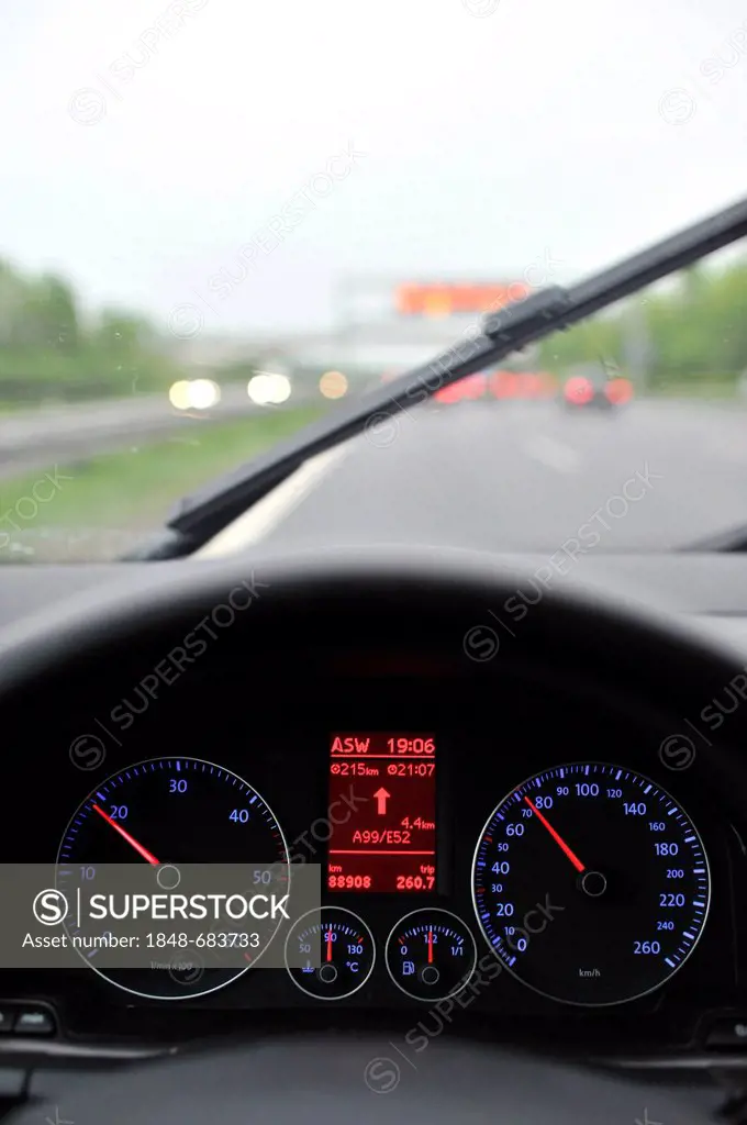 Poor visibility in rain, highway, illuminated speedometer with navigation display, driving VW Golf