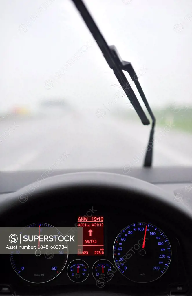 Poor visibility in rain, highway, illuminated speedometer with navigation display, driving VW Golf