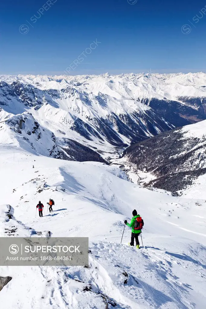 Ski tourers descending Mt. Hintere Schoentaufspitze, Solda in winter, behind the Suldental valley, South Tyrol, Italy, Europe