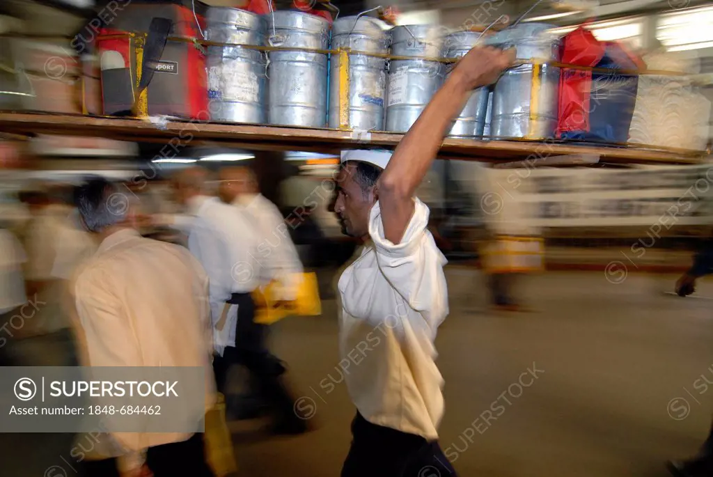 Dabba wallah or food deliverer with a pallet of Dabbas or food containers, Churchgate Station, Mumbai, India, Asia
